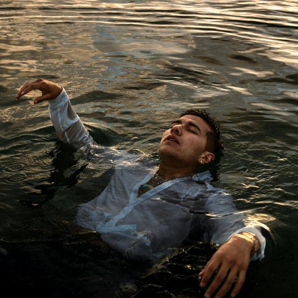 Person meditating peacefully outdoors with nature in the background.